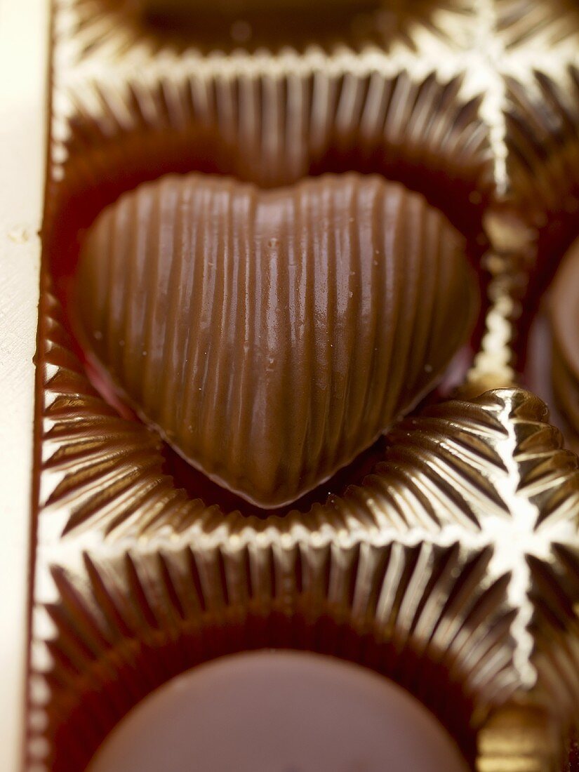 Heart-shaped chocolate in packaging (close-up)