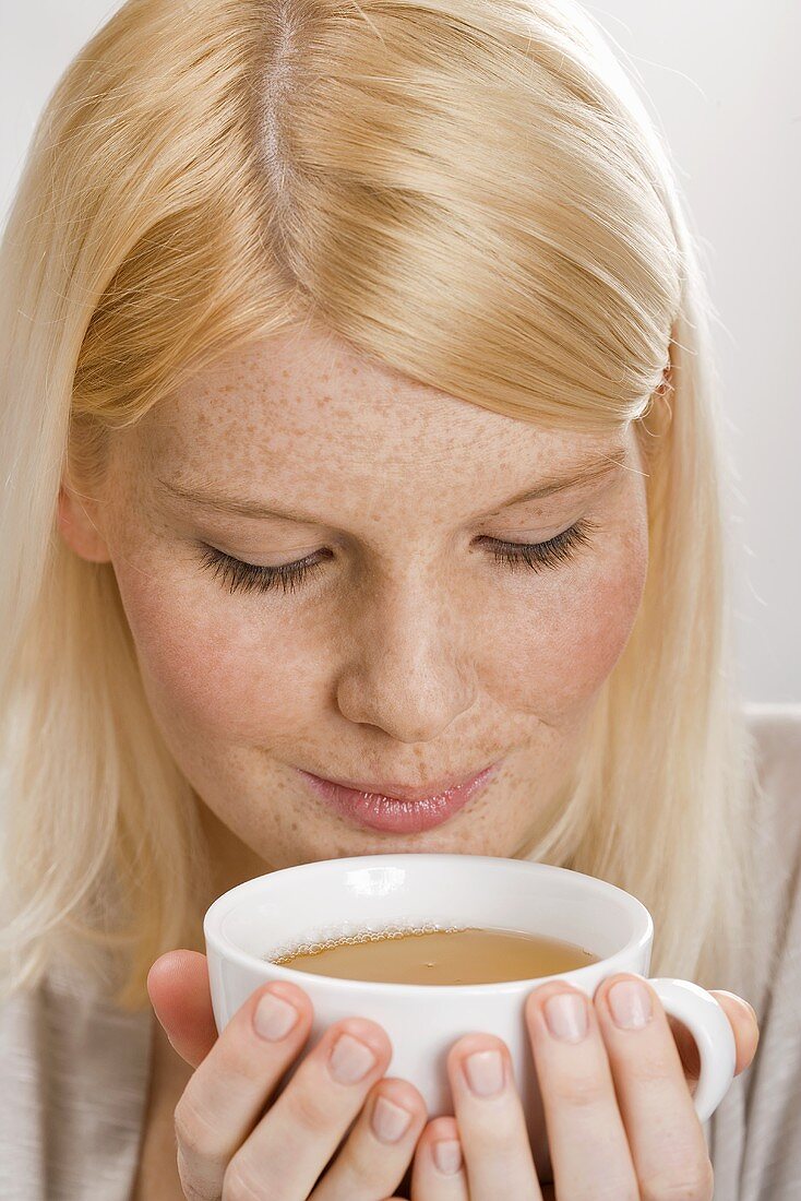 Blond woman drinking tea