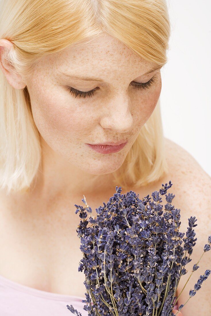 Blond woman holding bunch of lavender