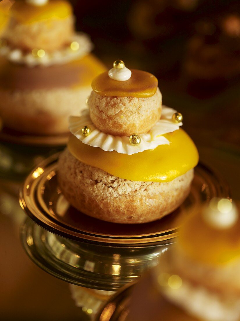 Almond macaroons with yellow icing and gold dragees