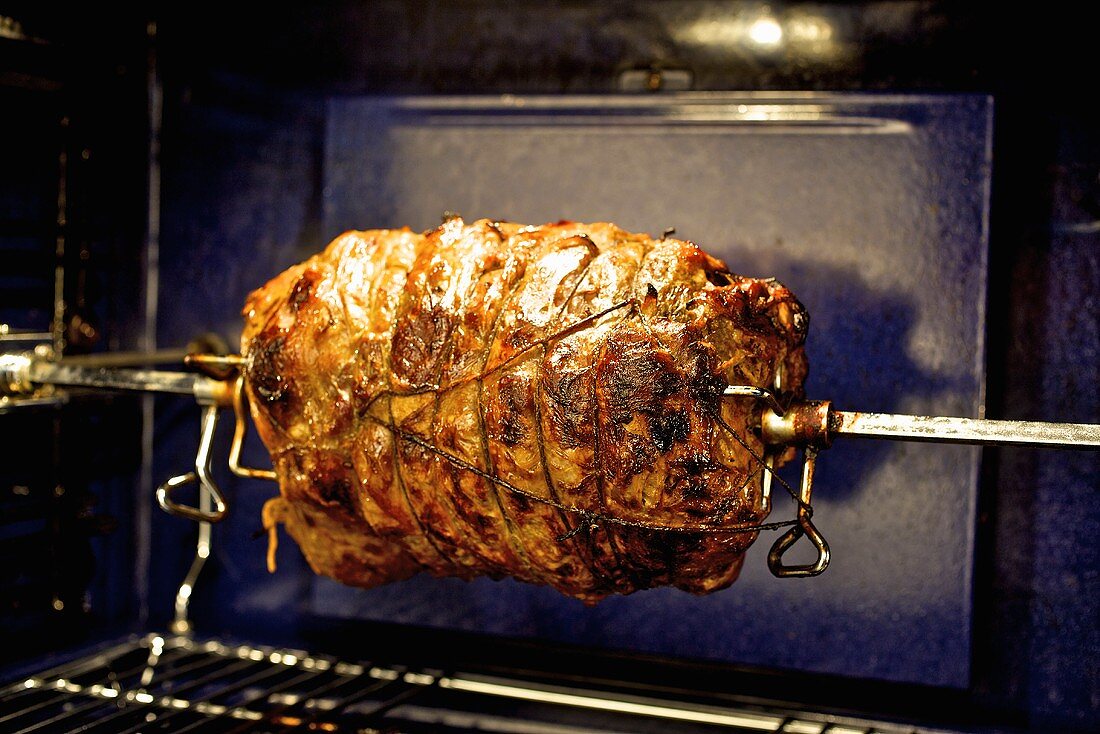 Roast beef on spit in oven