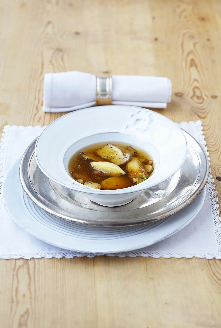 Clear cep soup with polenta dumplings
