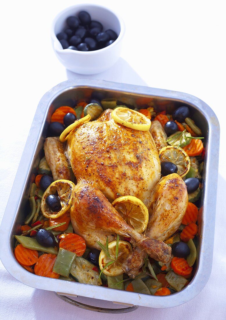 Roast chicken with olives, carrots and lemons