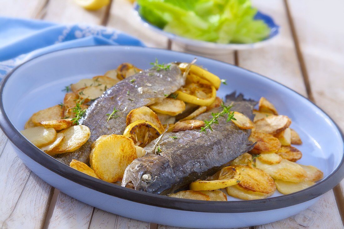 Fried trout with lemon and fried potatoes