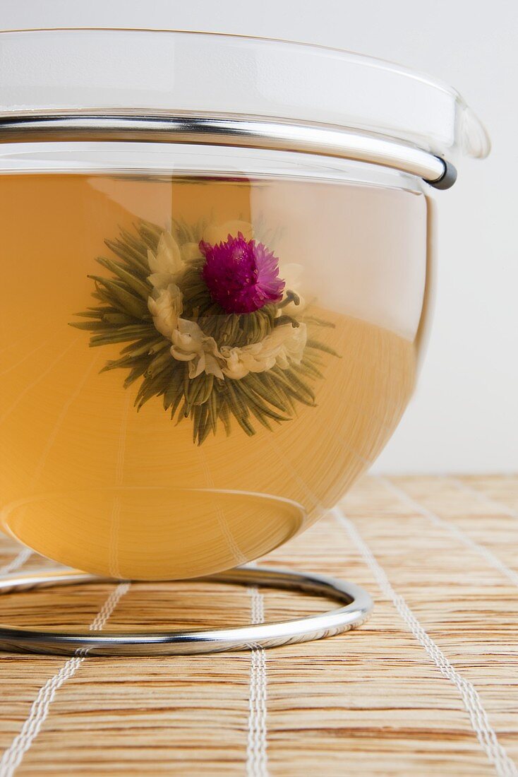 Tea with tea flower in glass jug