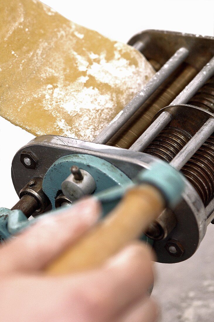 Hand operating old pasta maker
