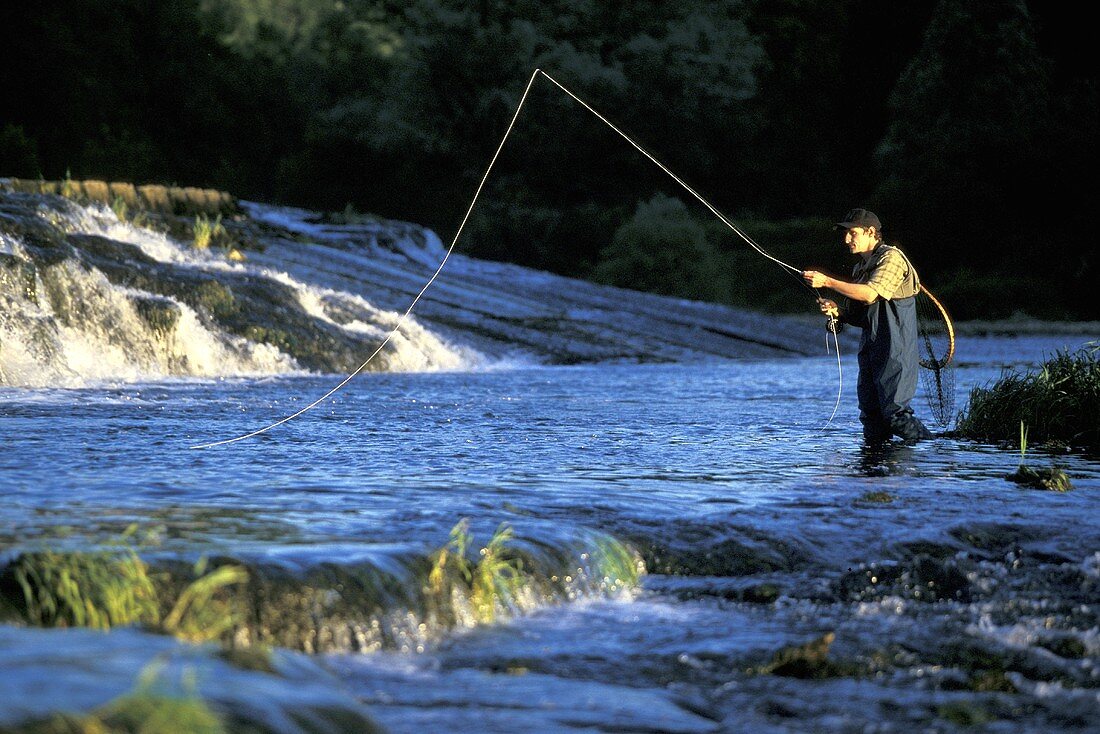 A man fly fishing in a mountain river