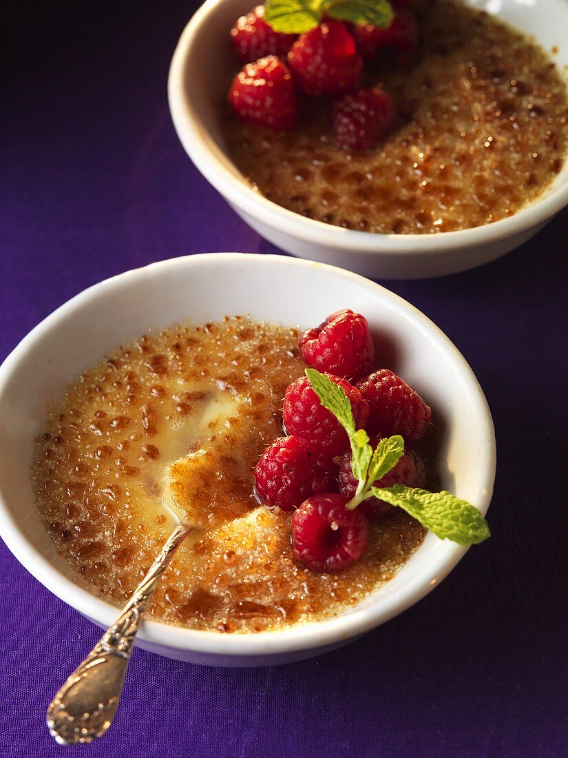 Sour cream crème brûlée with marinated raspberries