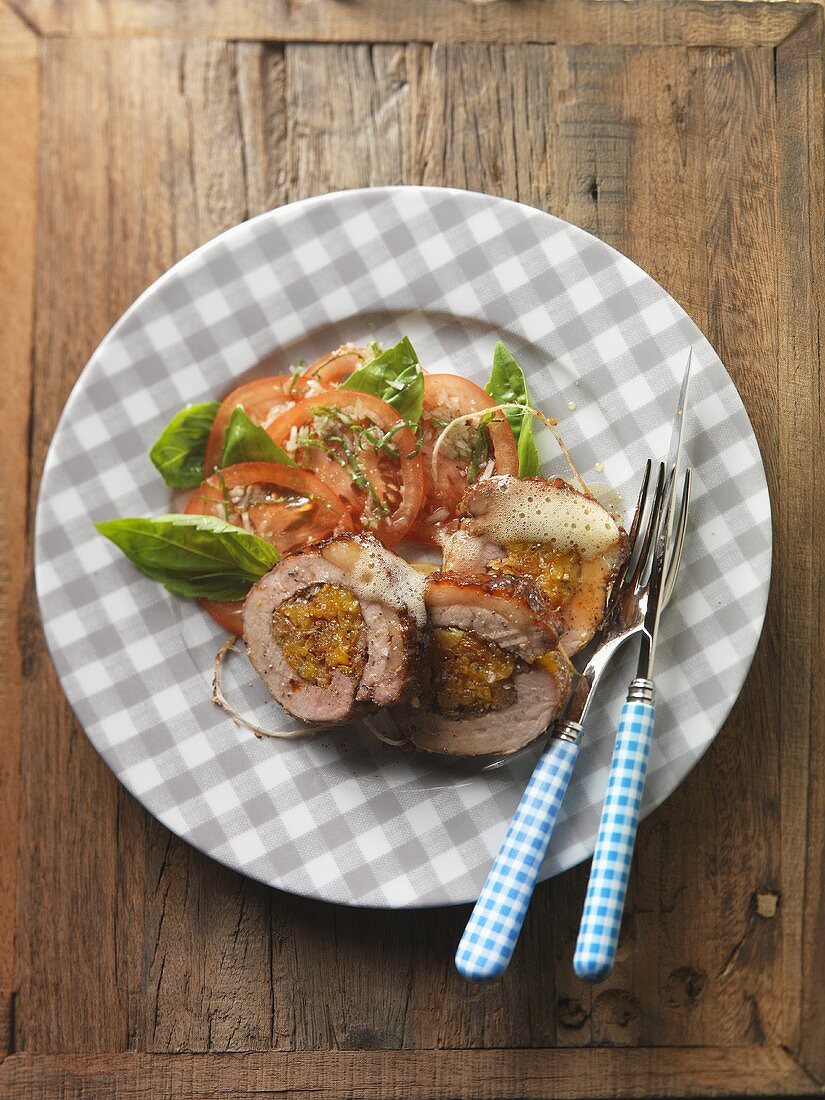 Stuffed breast of veal on tomato salad