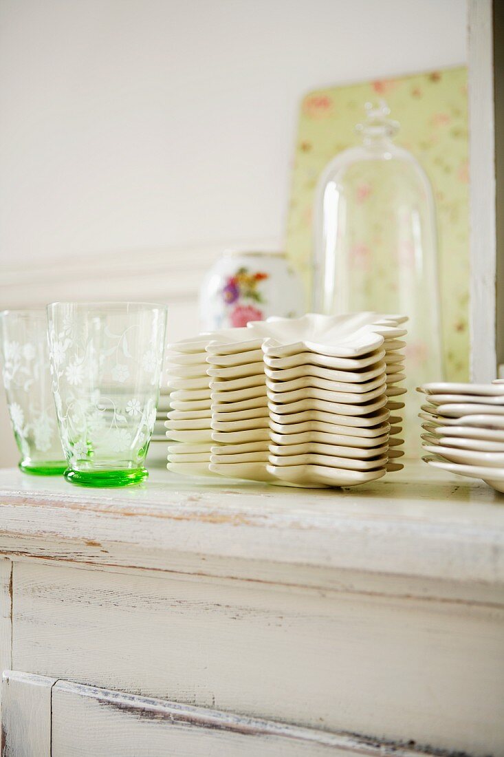 Crockery and glasses on a chest of drawers