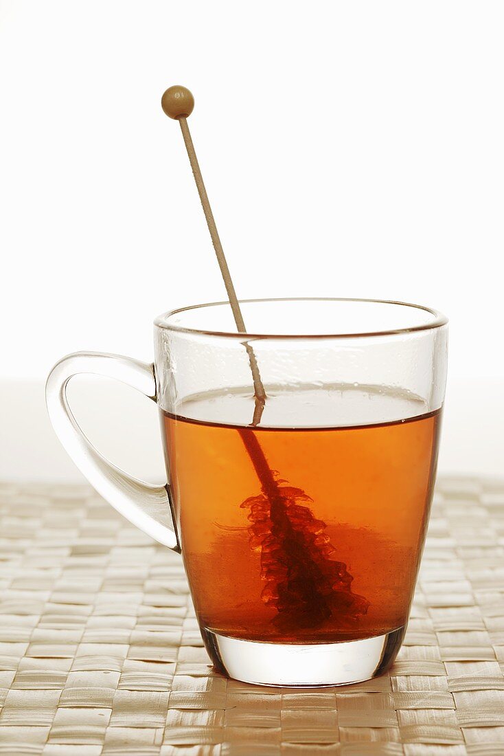Cup of tea with sugar swizzle stick