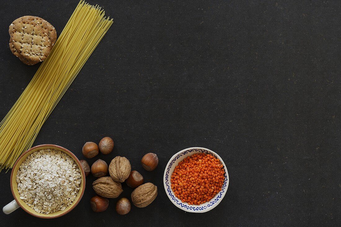 Still life with lentils, nuts, rice, spaghetti and crackers