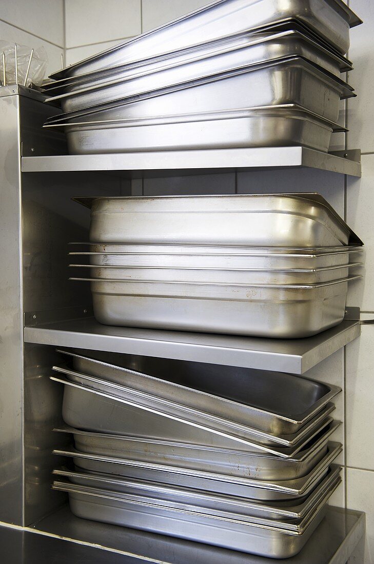 Stainless steel roasting tins, stacked