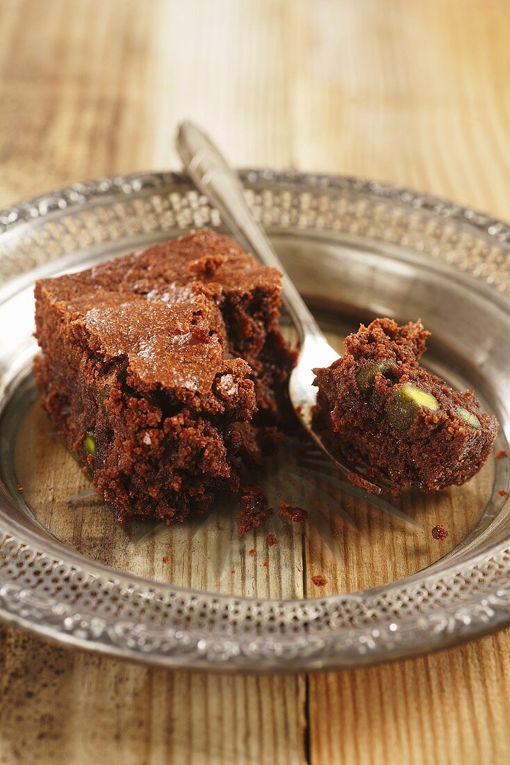 Pistachio brownie on plate with fork
