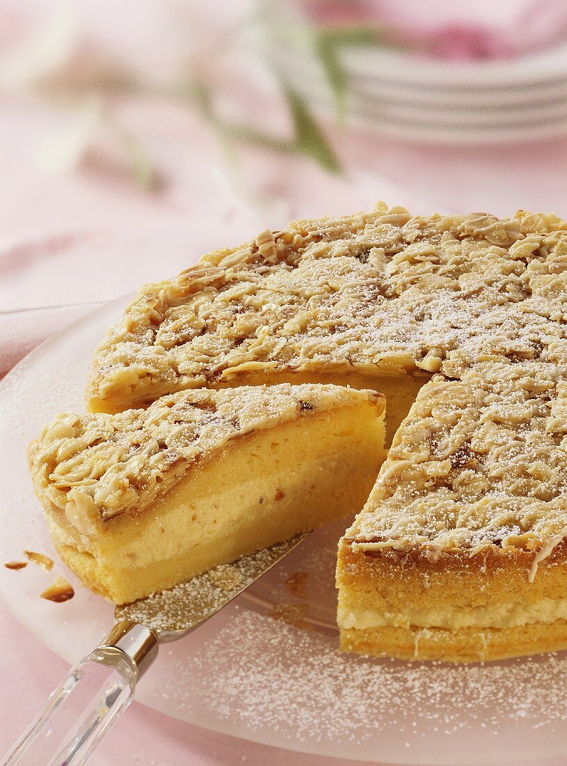 Filled almond cake, partly sliced