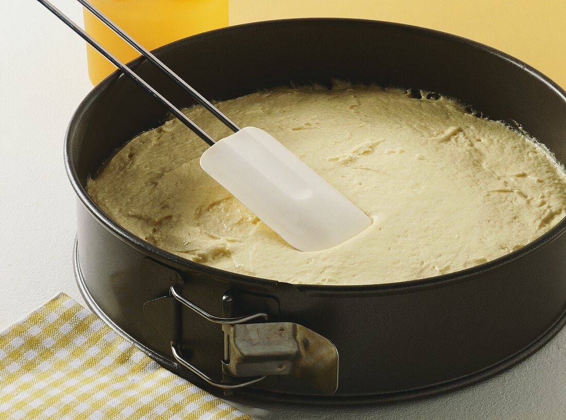 Spreading cake mixture smoothly in baking tin