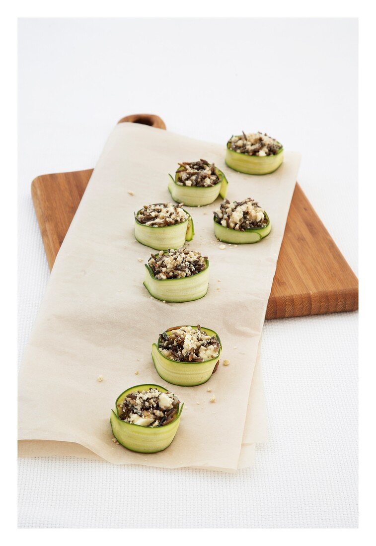 Courgette rolls with wild rice and nut filling