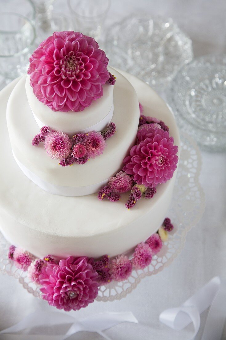 Three-tier wedding cake decorated with flowers