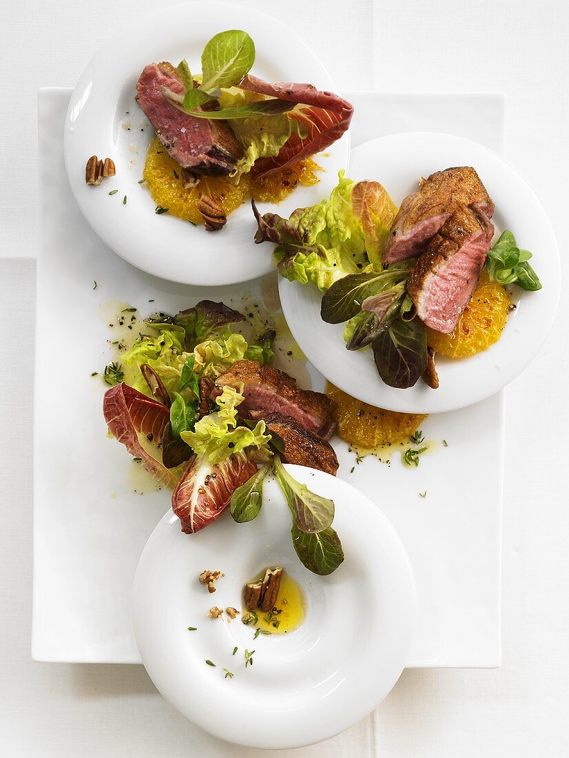 Duck breast with caramelised oranges on winter salad