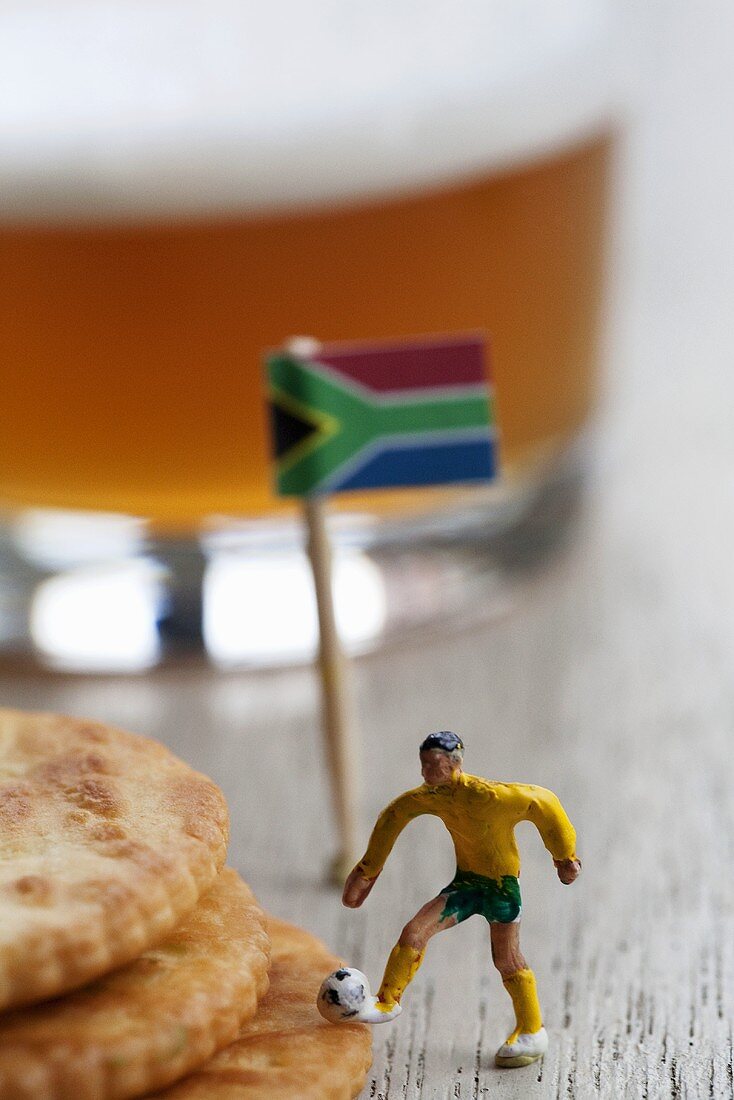 Toy football player, crackers and beer