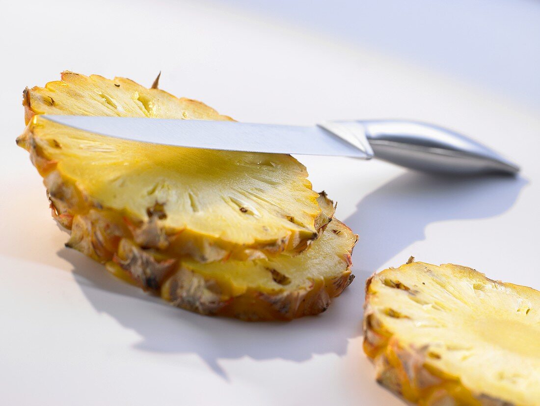 Slices of pineapple with knife