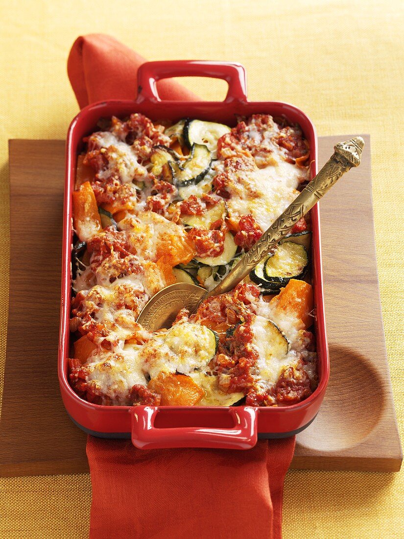 Pumpkin and courgette gratin in baking dish
