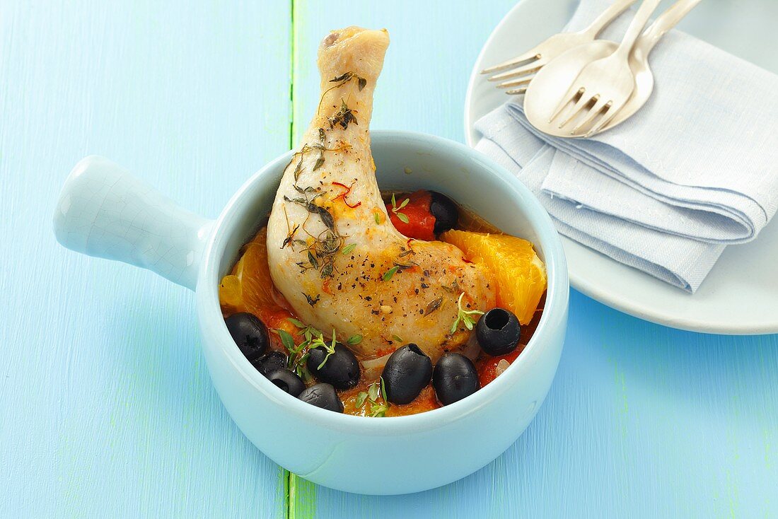 Chicken leg with tomatoes, olives, oranges and saffron