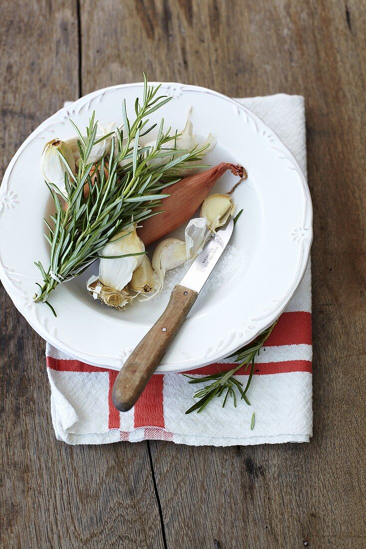 Onions, garlic and rosemary on a plate