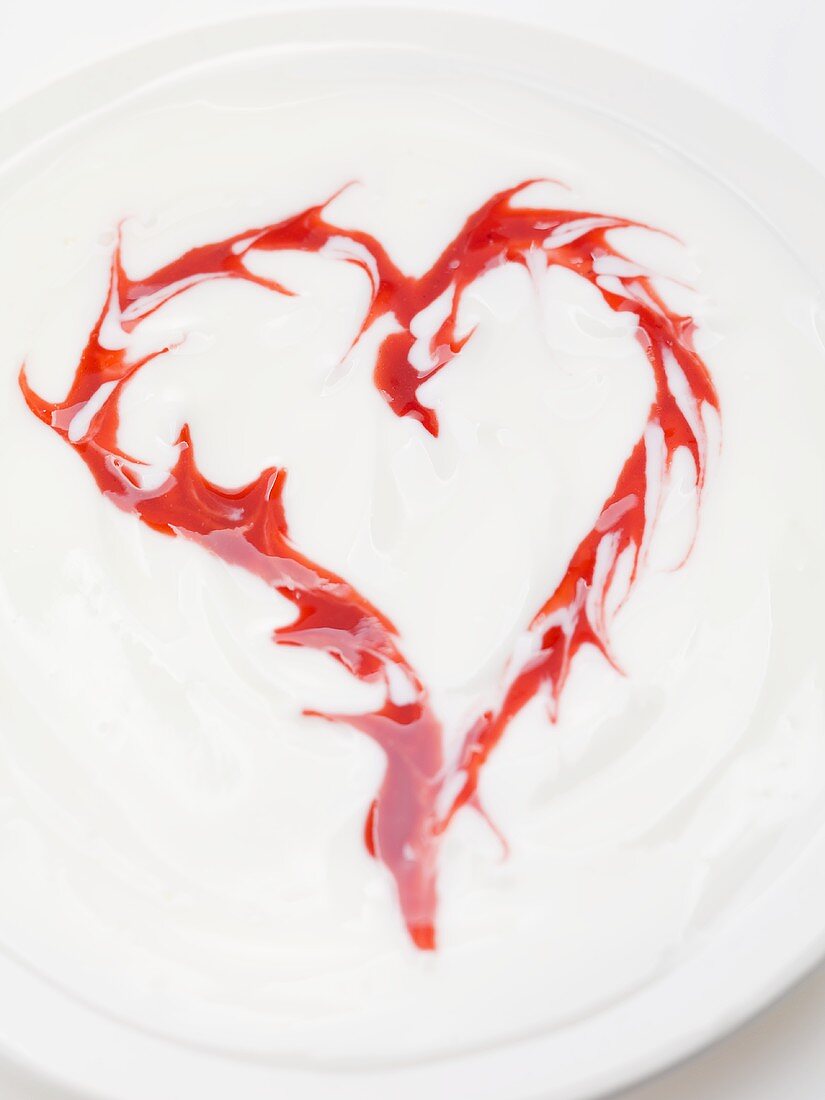 Yoghurt with raspberry sauce (forming a heart)