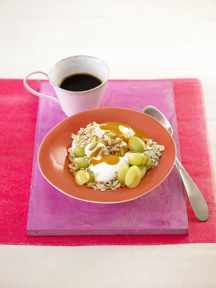 Muesli with yoghurt, grapes and pine nuts