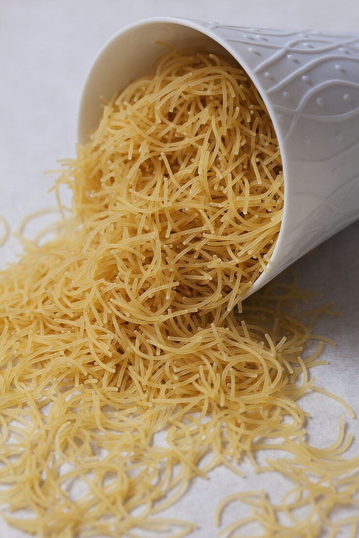Vermicelli falling out of upset beaker