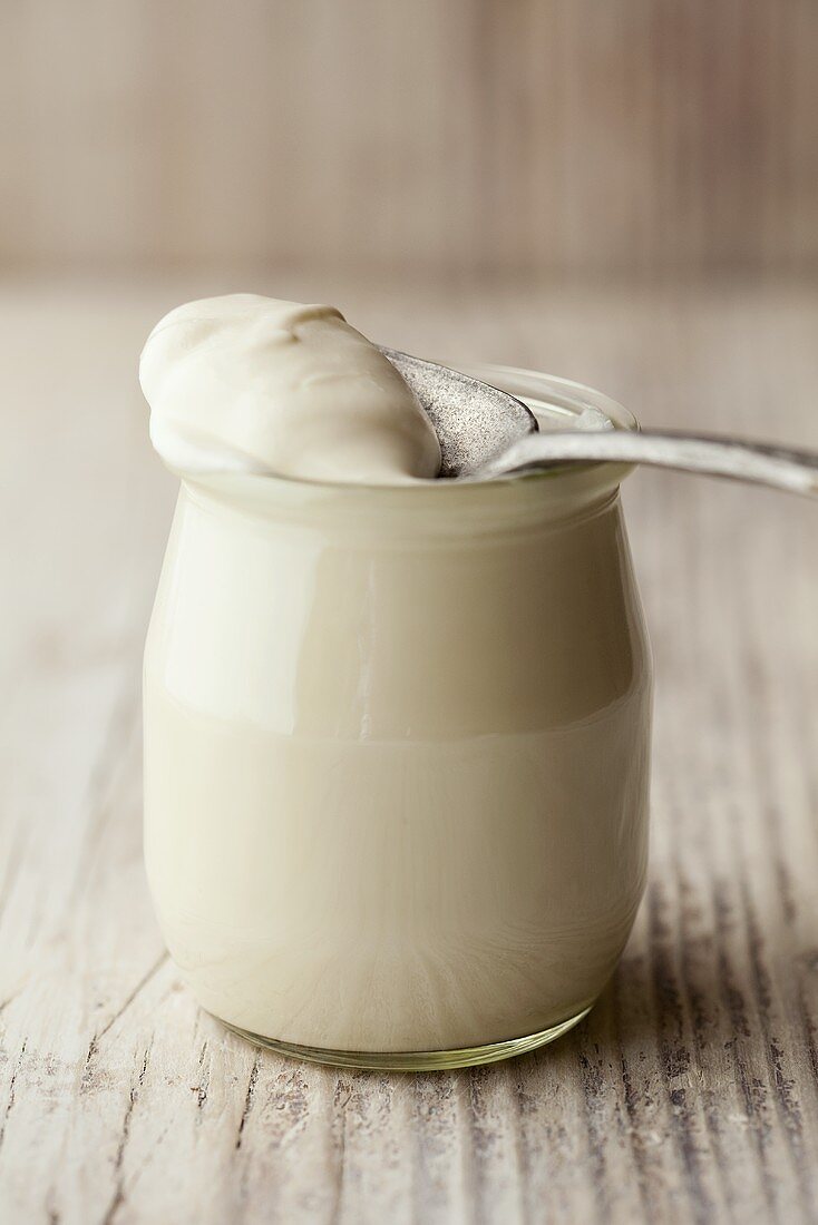 Natural yoghurt in glass with spoon