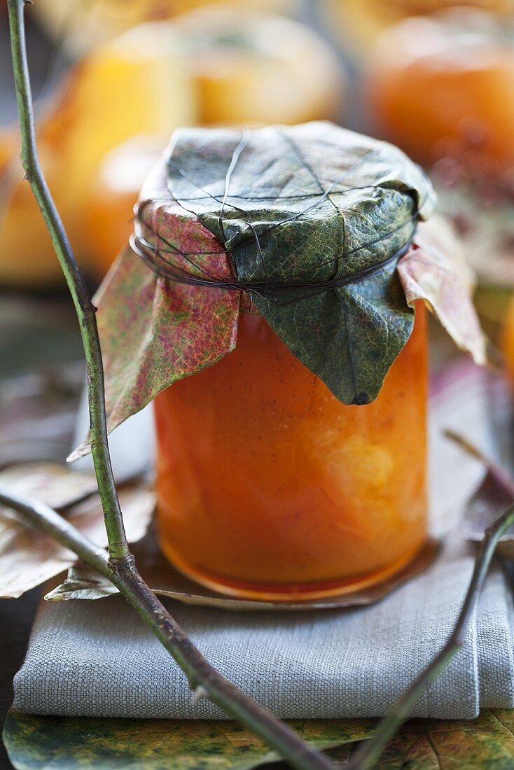 Persimmon and pumpkin chutney with ginger in jar