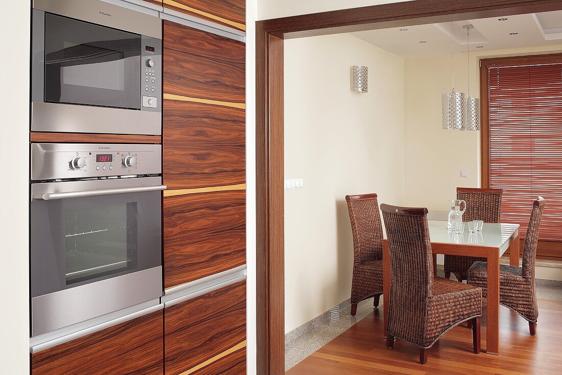 Kitchen with dining table and wicker chairs