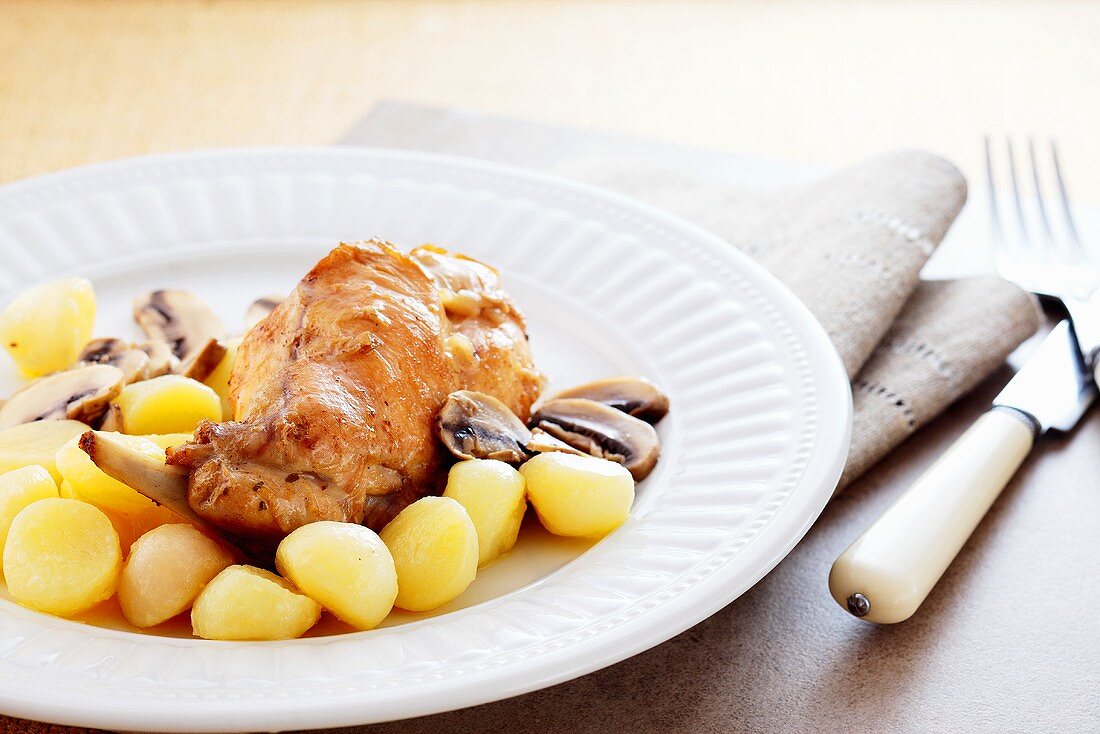 Rabbit leg with button mushrooms and potatoes