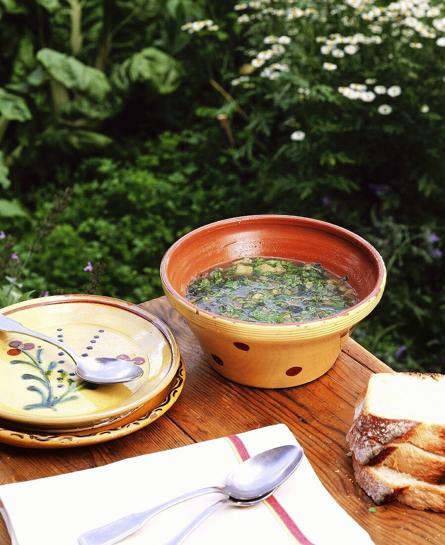 Nettle soup with bread out of doors