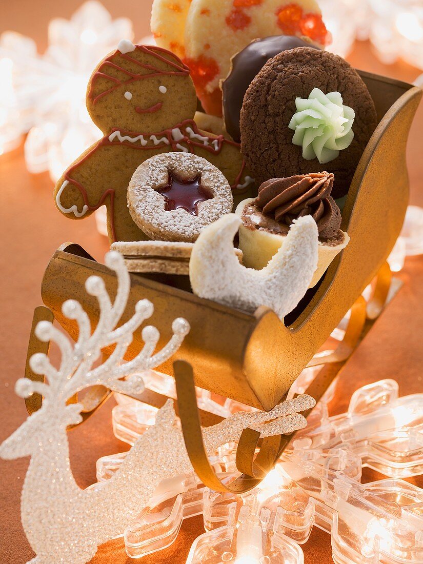 Various types of Christmas biscuits in a small sleigh