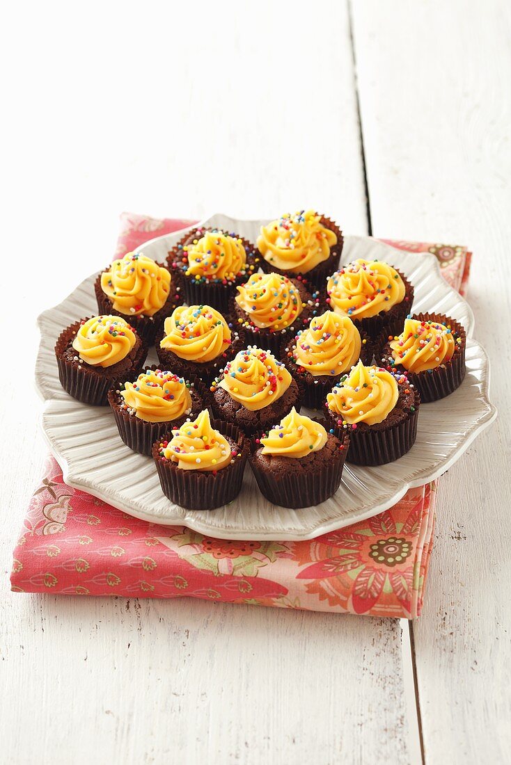 Small chocolate cupcakes with orange cream
