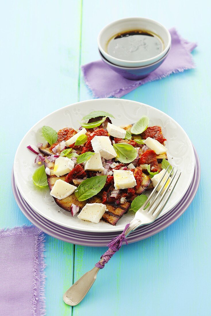 Grilled aubergine salad with dried tomatoes and goat's cheese