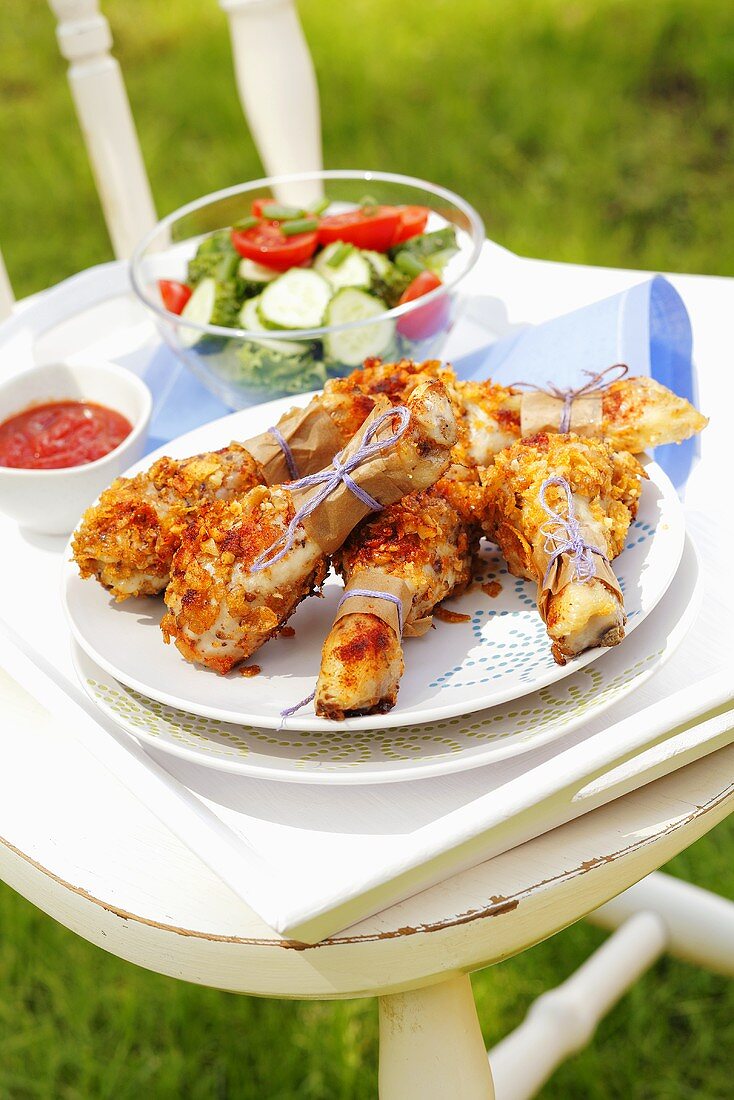 Chicken drumsticks coated in cornflakes and nuts