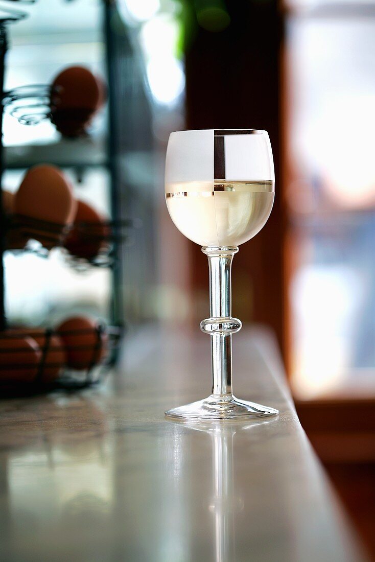 A glass of white wine on the bar in a pub