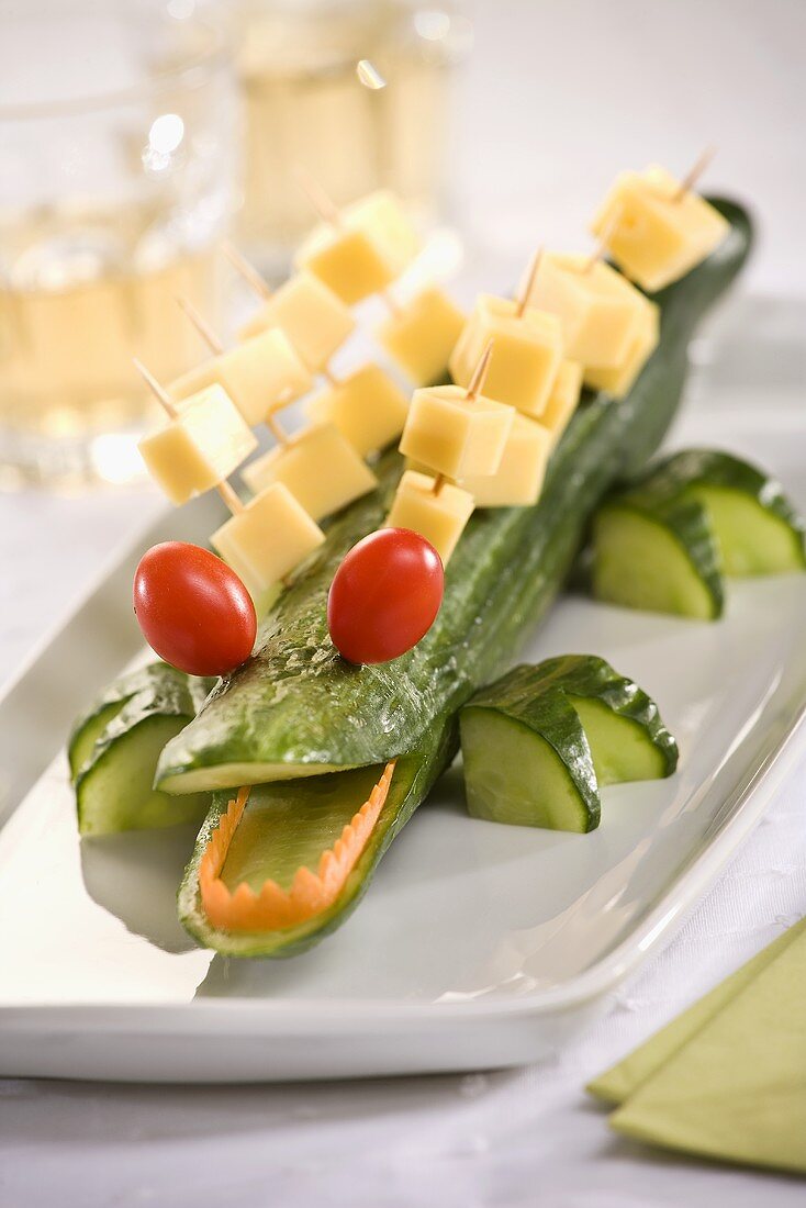 Cucumber crocodile with cherry tomatoes and cheese on cocktail sticks