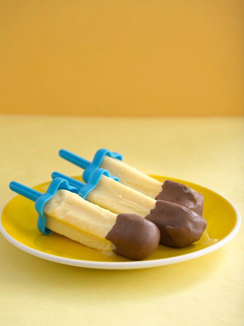 Peach and lemon grass ice creams with chocolate-coated tips