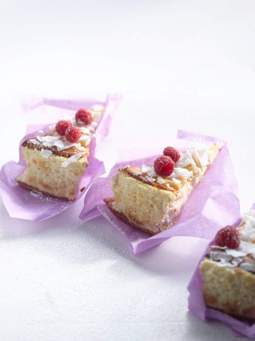 Lime and coconut cheesecake garnished with raspberries