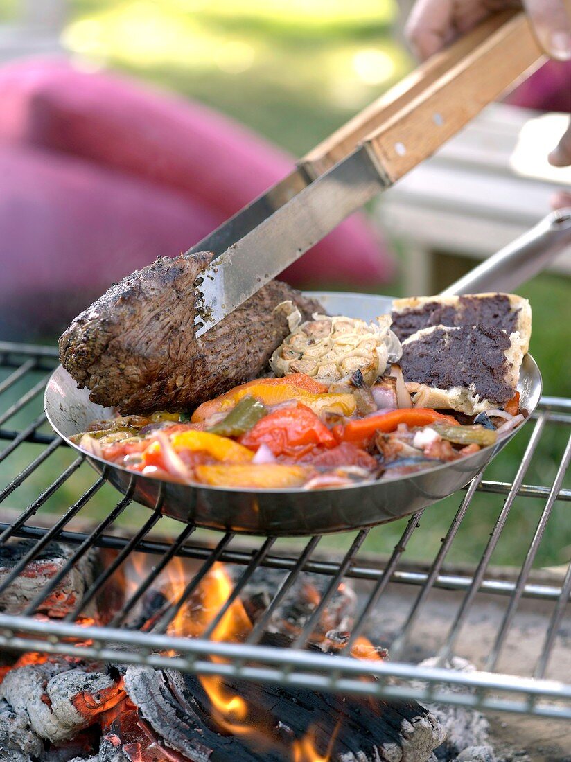 Barbecued beef fillet with vegetables, olive paste on bread