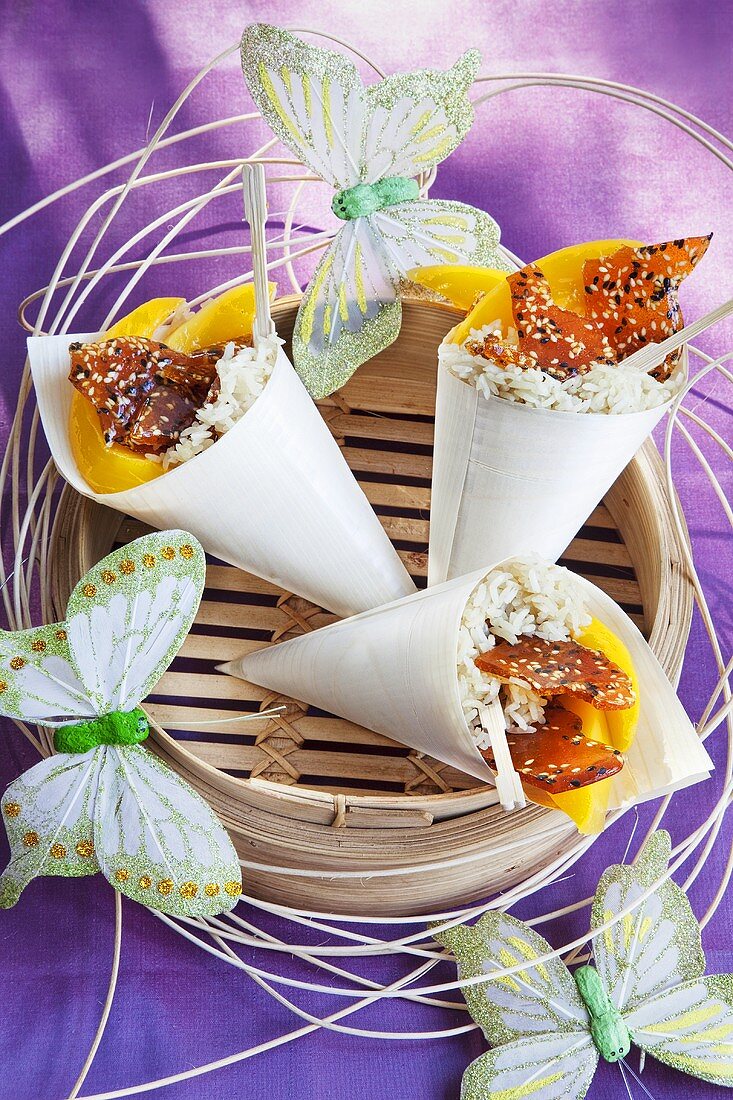 Paper cones of rice with mango and caramel