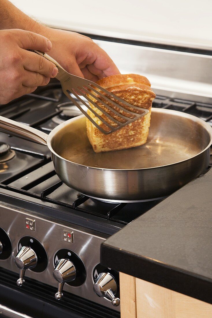 Toasting slices of brioche in a pan