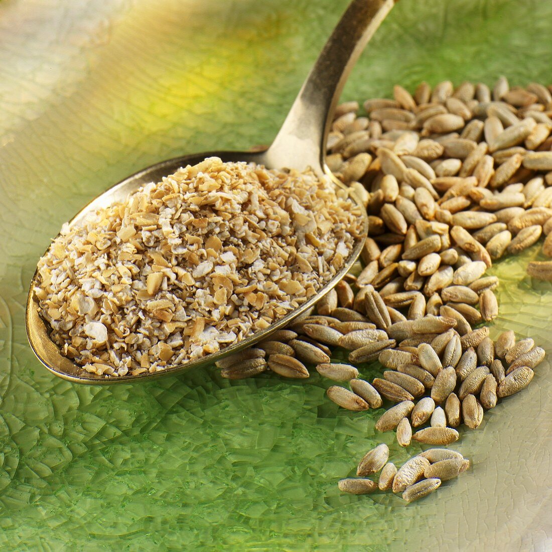Wheat bran on spoon, grains of rye