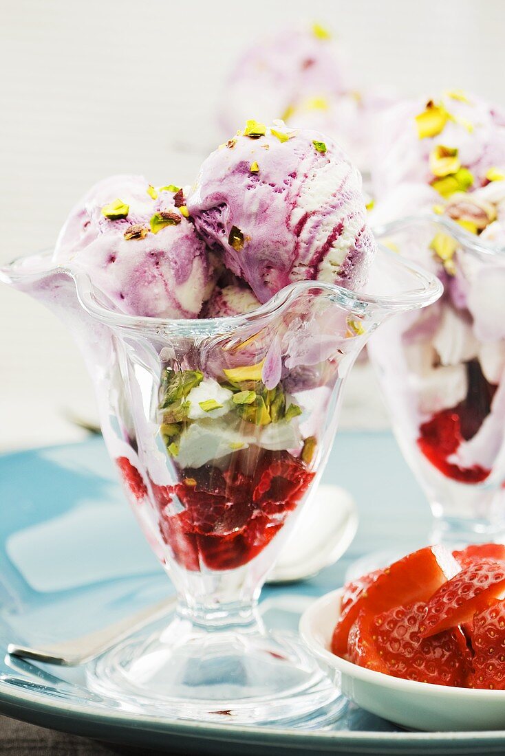 Ice cream sundae with berries and pistachios