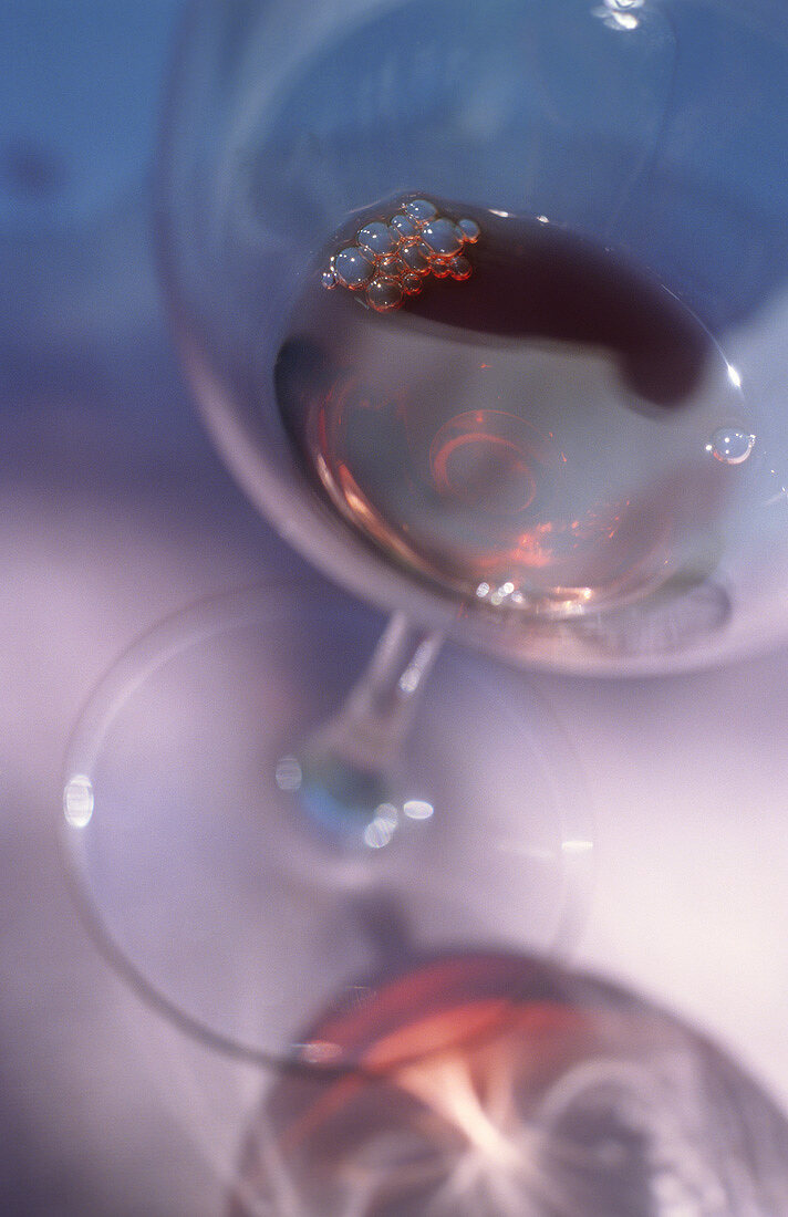 A mouthful of red wine in a glass